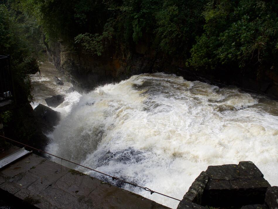 The spray of the waterfall, and a longer view towards the rest of the river.